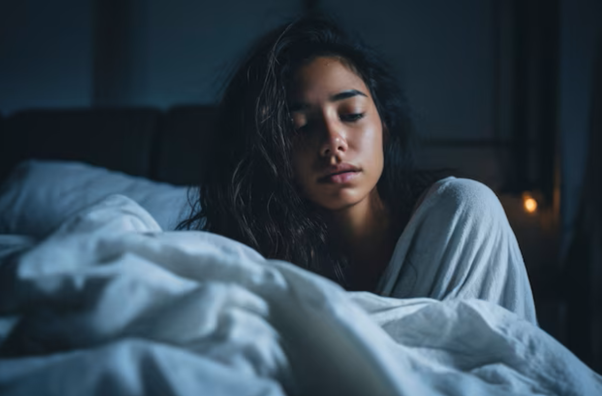 Woman lying awake in bed at night